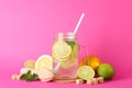 Glass jar with lemonade and ingredients on background Royalty Free Stock Photo