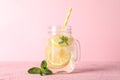 Glass jar with lemonade on pink background Royalty Free Stock Photo