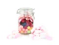 Glass jar with many bright sweet candies and marshmallows
