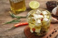 Glass jar of marinated feta cheese on wooden table Royalty Free Stock Photo
