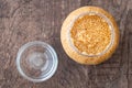 Glass jar of minced garlic and small glass bowl on wood background Royalty Free Stock Photo