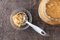 Glass jar of minced garlic and small glass bowl on wood background, with stainless steel tablespoon in bowl with garlic Royalty Free Stock Photo