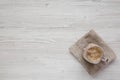 Glass jar mug filled with coffee, oat and banana smoothie on a white wooden background, top view. Flat lay, overhead, from above. Royalty Free Stock Photo