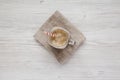 Glass jar mug filled with coffee, oat and banana smoothie on a white wooden table, top view. Flat lay, overhead, from above Royalty Free Stock Photo