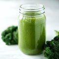 Glass jar mugs with green health smoothie and kale leaves. Copy space. Raw, vegan, vegetarian, alkaline food concept