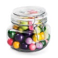 Glass jar with multicolored candies isolated on white