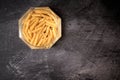 Glass jar with open macaroni pasta on a dark background Royalty Free Stock Photo