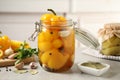 Glass jar with pickled peppers on table Royalty Free Stock Photo