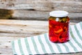 Glass jar with pickled red bell peppers.Preserved food concept, canned vegetables isolated in a rustic composition Royalty Free Stock Photo