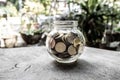 Glass jar piggy bank with coins. Plan your savings, run a growing business for success and save for retirement Royalty Free Stock Photo