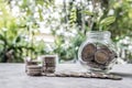 Glass jar piggy bank with coins. Plan your savings, run a growing business for success and save for retirement Royalty Free Stock Photo