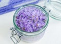 Glass jar with purple bath salts foot soak wirh dry lavender flowers. Close up, copy space Royalty Free Stock Photo