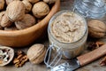 Glass jar of raw organic walnut butter or paste. Top view