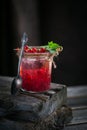 Glass jar of red currant soda drink on dark wooden table. Summer healthy detox lemonade, cocktail or another drink background. Low Royalty Free Stock Photo