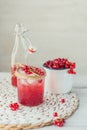 Glass jar of red currant soda drink on white wooden table. Summer healthy detox lemonade, cocktail or another drink background. Royalty Free Stock Photo