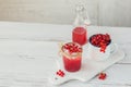 Glass jar of red currant soda drink on a white wooden table. Summer healthy detox lemonade, cocktail or another drink background. Royalty Free Stock Photo