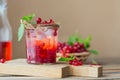 Glass jar of red currant soda drink on wooden table. Summer healthy detox lemonade, cocktail or another drink background. Low Royalty Free Stock Photo