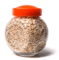 Glass jar with rolled oats on white background glass jar with oatmeal flakes Royalty Free Stock Photo