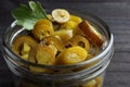 Glass jar with slices of pickled green jalapeno peppers on black wooden table, closeup Royalty Free Stock Photo