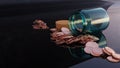 Glass jar with spilled bitcoin coins on reflective dark surface Royalty Free Stock Photo