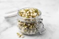 Glass jar with sprouted green mung beans on white marble table, closeup Royalty Free Stock Photo