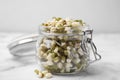 Glass jar with sprouted green mung beans on white marble table, closeup Royalty Free Stock Photo