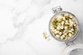 Glass jar with sprouted green mung beans on white marble table, top view. Space for text Royalty Free Stock Photo