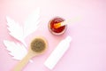 Glass jar with sugar paste for hair removal, massage brush, white jar with cosmetic on a pink background Royalty Free Stock Photo