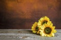 Glass jar with sunflowers on a wooden table Royalty Free Stock Photo