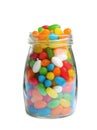 Glass jar of tasty jelly beans on background Royalty Free Stock Photo