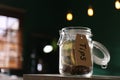 Glass jar with tips on wooden table indoors, closeup. Space for text Royalty Free Stock Photo