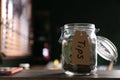 Glass jar with tips on wooden table indoors, closeup. Space for text Royalty Free Stock Photo