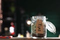 Glass jar with tips on wooden table indoors. Space for text Royalty Free Stock Photo