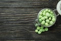 Glass jar with wasabi nuts on rustic wooden background