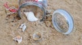 a glass jar from which sand with shells spills out