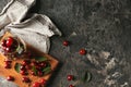 Glass jar and wooden board with fresh ripe cherries on grey textured background Royalty Free Stock Photo