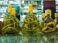 Glass jars with alcoholized snakes are on a glass table with reflection in Chinese traditional pharmacy boxes Royalty Free Stock Photo