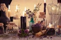 Glass jars and bottles with black candles and healing herbs on the alchemical table Royalty Free Stock Photo