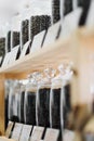 Glass jars of coffee beans stand on the shelf of the store. Royalty Free Stock Photo