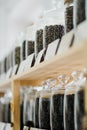 Glass jars of coffee beans stand on the shelf of the store. Royalty Free Stock Photo