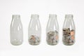 Glass jars with coins like diagram, isolated - savings concept Royalty Free Stock Photo