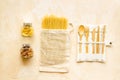 Glass jars, cotton bags on beige background, top view. Eco friendly concept for kitchen - food storage