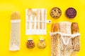 Glass jars, cotton bags on yellow background, top view. Eco friendly concept for kitchen - food storage