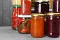 Glass jars with different pickled foods on grey background, closeup Royalty Free Stock Photo