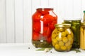 Glass jars with different pickled vegetables on wooden background. Space for text Royalty Free Stock Photo