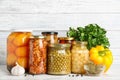Glass jars with different pickled vegetables on wooden table Royalty Free Stock Photo