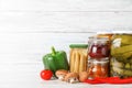 Glass jars with different pickled vegetables on wooden table. Space for text Royalty Free Stock Photo