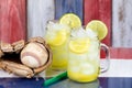 Glass jars filled with cold lemonade and baseball mitt with ball Royalty Free Stock Photo