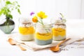 glass jars filled with layered chia pudding and mango