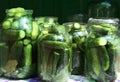 Glass jars with fresh ripe cucumbers on table. Pickling vegetables Royalty Free Stock Photo